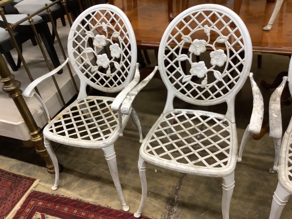 A set of four white painted alumiunum garden elbow chairs, width 57cm depth 55cm height 98cm